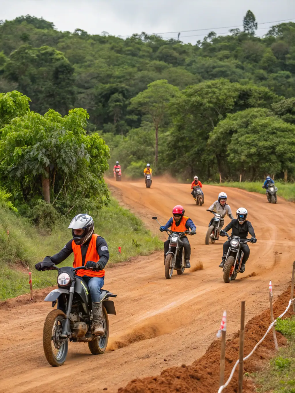 An instructor demonstrating riding techniques to a group of attentive riders on a private circuit, highlighting the Training and Educational Workshops provided by TRS ASS TEAM ROUDY SPORT.